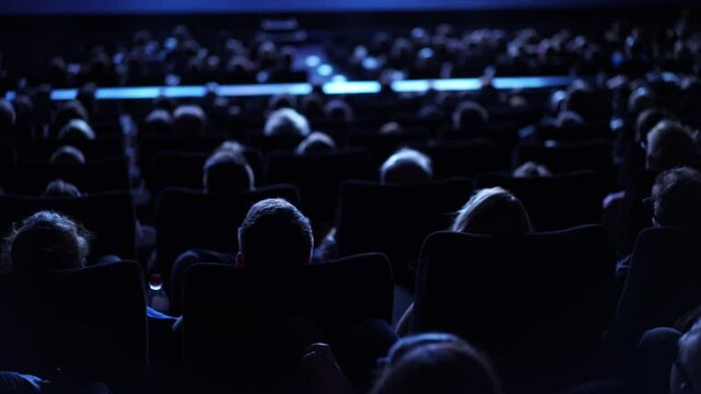 Large crowd of people during a film performance - cinema
