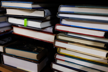 Books stacked on shelves in a small city bookstore.