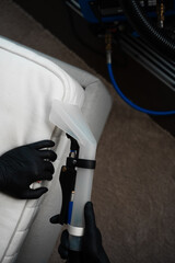 Mattress dry washing using extractor. Cleaner is using extractor machine to clean the bed mattress in the house. Absorbing the dirt from the fibers of sofa with extractor.