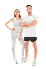 Beautiful young happy couple in sportswear isolated on white background