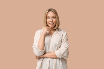 Fototapeta premium Beautiful young woman with bob hairstyle on brown background