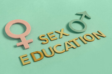 Letters with text SEX EDUCATION, male and female symbols on blue background