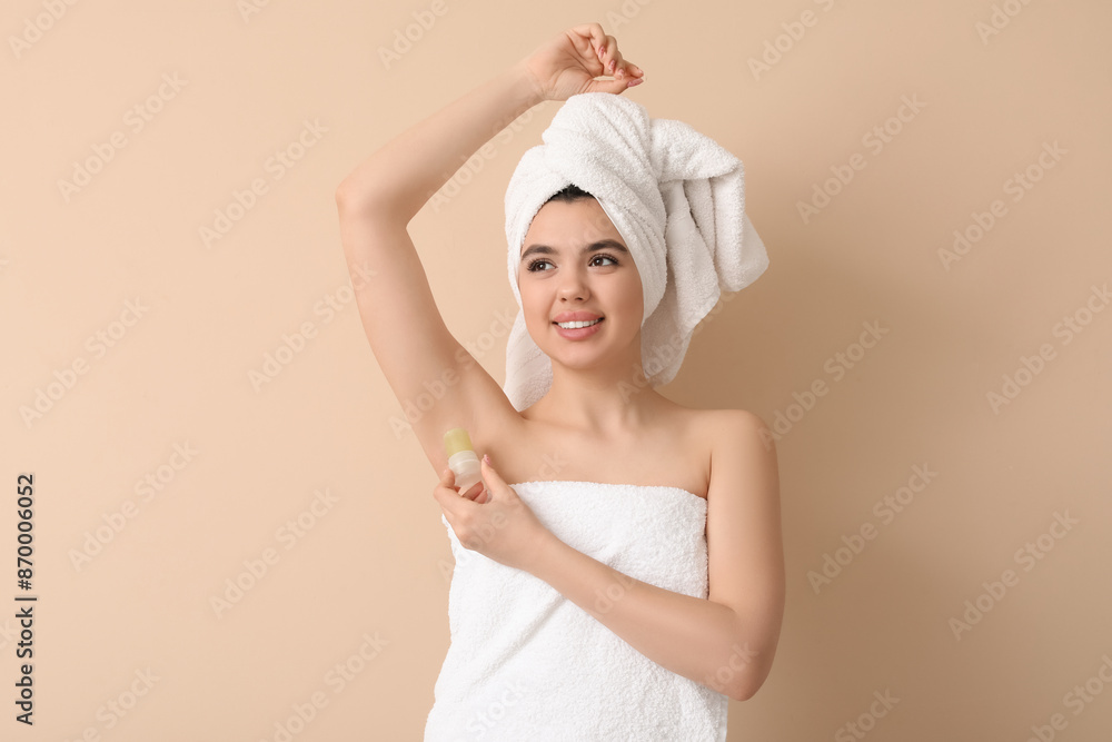 Poster happy smiling young woman in towel using crystal deodorant on beige background