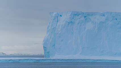 Iceberg Towers Above Us Travel Photography Blue Ice Formation with Mountains in Distance. View From...