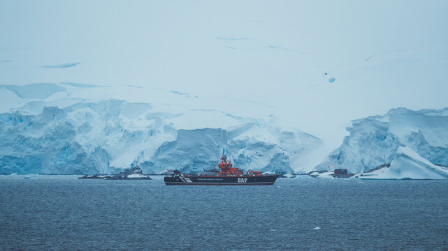 Neumayer Channel, Antarctica - December 28th 2023: Photo from Cruise Ship of DAP Science Vessel Helicopter Carrier in Front of Ice Shelf Snow