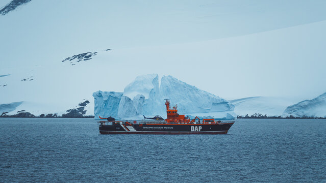 Neumayer Channel, Antarctica - December 28th 2023: Photo from Cruise Ship Close Up of DAP Science Vessel Helicopter Carrier in Front of Ice Shelf Snow