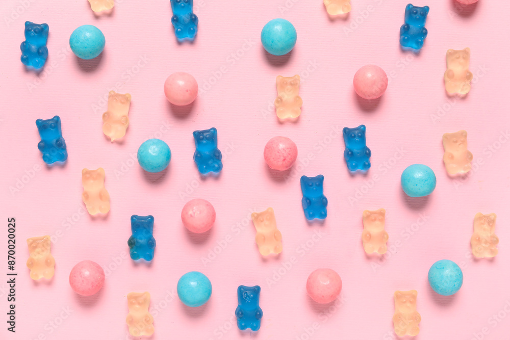 Wall mural Colorful jelly bears and sweets on pink background