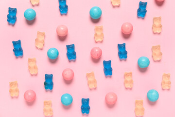 Colorful jelly bears and sweets on pink background