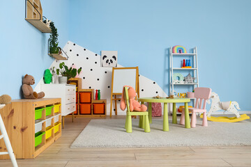 Shelving unit and table with chairs in playroom
