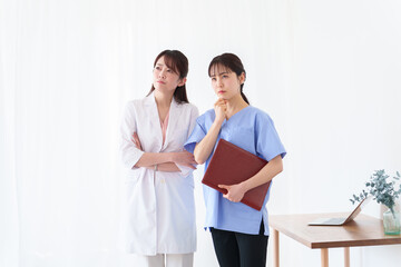 考える女性の医師と看護師