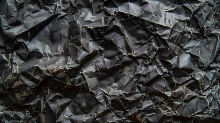Wrinkled black old wrinkled paper. Dusty cardboard wrapping