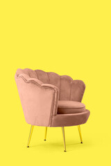 Pink armchair on yellow background