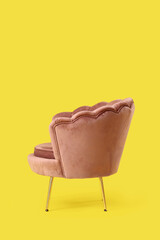 Obraz premium Pink armchair on yellow background