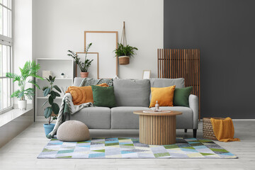 Interior of modern room with comfortable sofa and coffee table