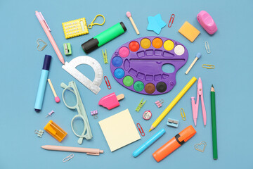Eyeglasses and different stationery on blue background
