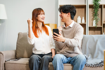 Young women, men, and Asian people prepare for moving into a new home. From unpacking supplies to updating documents, follow a comprehensive checklist in the living room with a big cardboard box.