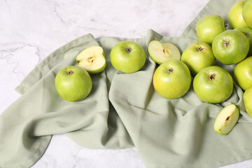 Fresh ripe green apples on white marble table