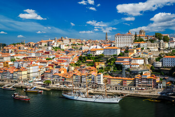 Obraz premium Aerial view of Porto city and Douro river with moored sailling ship from Dom Luis bridge I. Porto, Portugal