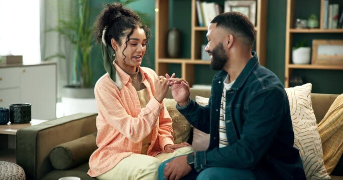 Couple, home and happy with pinky promise in sofa for fun, enjoy and love with support and trust. People, relationship and smile or laugh with joy on couch in living room with agreement on commitment