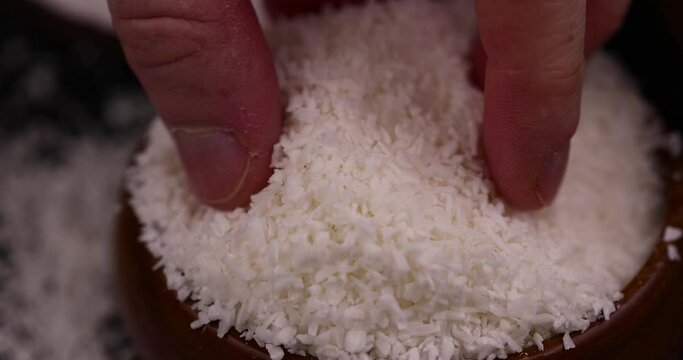 dry white coconut chips for adding to desserts, finely chopped coconut pulp dried in sugar syrup