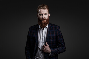Fototapeta premium Man businessman in bespoke formalwear. Business man in elegant tailored suit. Formal tailored suit. Gentleman menswear. Bespoke suit. Bearded man in tailored formal menswear. Formal attire