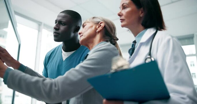Xray, doctor and conversation with meeting, collaboration and planning for surgery with scan. Professional, surgeon and clinic care with injury results and study of people with health assessment