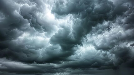 Obraz premium A sky filled with dark, ominous storm clouds, rumbling with distant thunder, evokes both fear and awe of nature's power.