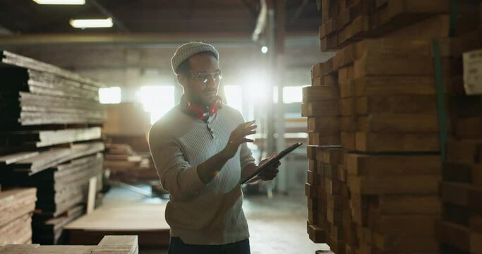 Man, carpenter and tablet in workshop for inspection or safety compliance and material or wood evaluation, Manager, online and quality assurance for carpentry assessment and digital documentation.