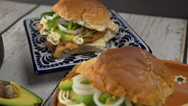 Mexican cake of breaded steak ,Avocado, Oaxaca cheese and onion rings