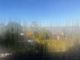 a wet humid window with condensation and mould 