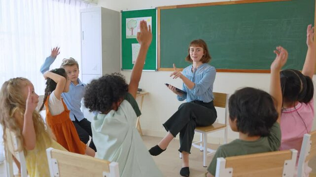 Caucasian young woman teacher teaching student in classroom at school. - Powered by Adobe