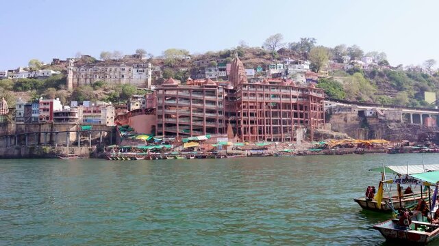 ancient hindu pilgrimage temple at holy river bank at morning from different perspective video is taken at omkareshwar khandwa madhya pradesh india.