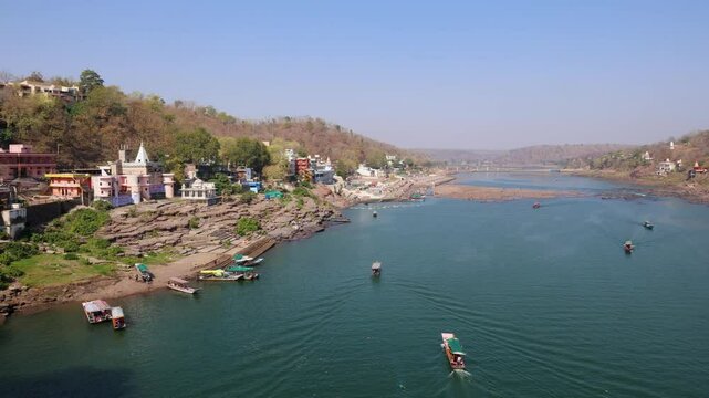 pristine river with tourist ferry boats at morning aerial view video is taken at omkareshwar khandwa madhya pradesh india.