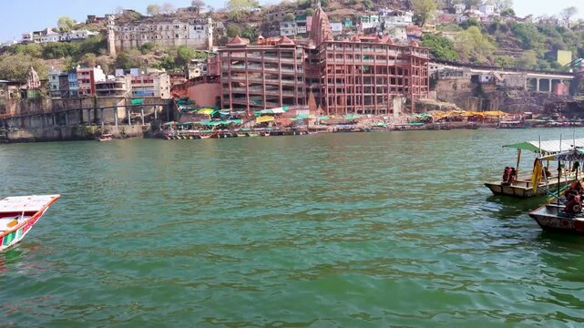 ancient hindu pilgrimage temple at holy river bank at morning from different perspective video is taken at omkareshwar khandwa madhya pradesh india.