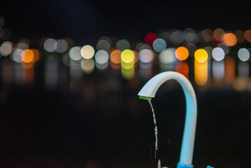Water tap with dim light bokeh background
