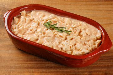 homemade chicken stroganoff in ceramic bowl on rustic wooden table