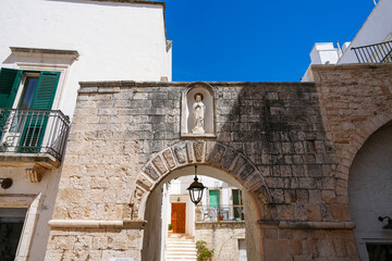 Stone archway and green doorways of Locorotondo