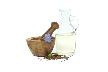 Linseed and linseed oil in glass decanter on white