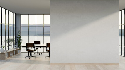 A modern, minimalist office corridor features a white wall, a parquet floor, and a meeting space.