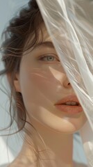 A delicate portrait showcasing a serene young woman partially obscured by a translucent veil, emphasizing natural beauty and soft lighting.