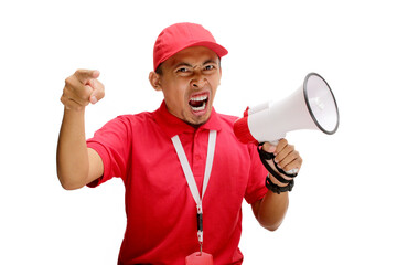 Angry Asian delivery man or courier in a red delivery uniform, wearing a red cap and polo shirt, pointing at the camera and shouting into a megaphone, isolated on a white background