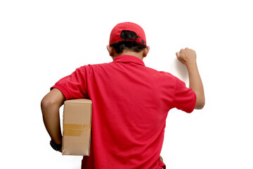 Asian delivery man or courier gesturing a knocking-the-door gesture, symbolizing delivering a package to the customer's front door, representing express delivery concept, isolated on white background