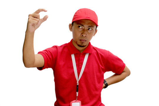 Asian delivery man is gesturing a small size with his finger, indicating something not very big, demonstrate tiny size gesture. Insecurity and lack of confidence concept. Isolated on white background