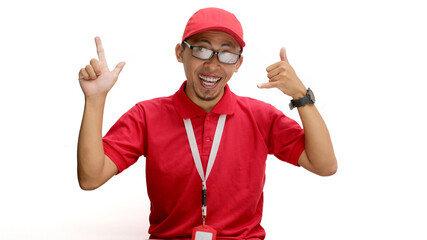 Asian delivery man or courier stands confidently against a white background, pointing left at the copy space while making a friendly 'call me' gesture with his other hand.