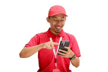 Excited Asian delivery man or courier expressing amazement while pointing at his phone. Isolated on a white background