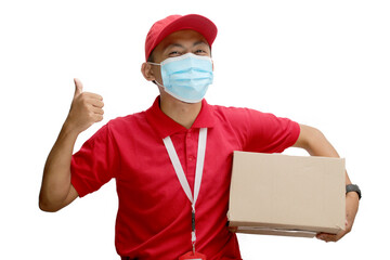 Asian delivery man wearing face mask, giving thumbs-up gesture at the camera while holding a package cardboard. Courier at work during the pandemic coronavirus outbreak, isolated on awhite background