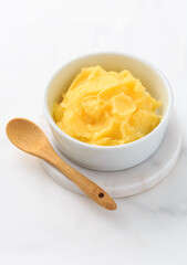 Ghee or clarified butter in jar and bowl. Indian butter.