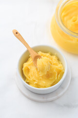 Ghee or clarified butter in jar and bowl. Indian butter.