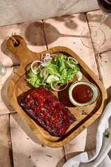 BBQ Ribs with Sauce and Green Salad in Sunlit Still Life Setting
