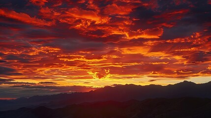 Fototapeta premium The dramatic colors of a sunset sky, with shades of red, gold, and violet, create a stunning natural painting that captivates the eye.